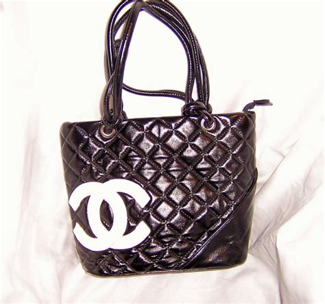 black quilted chanel bag with white logo